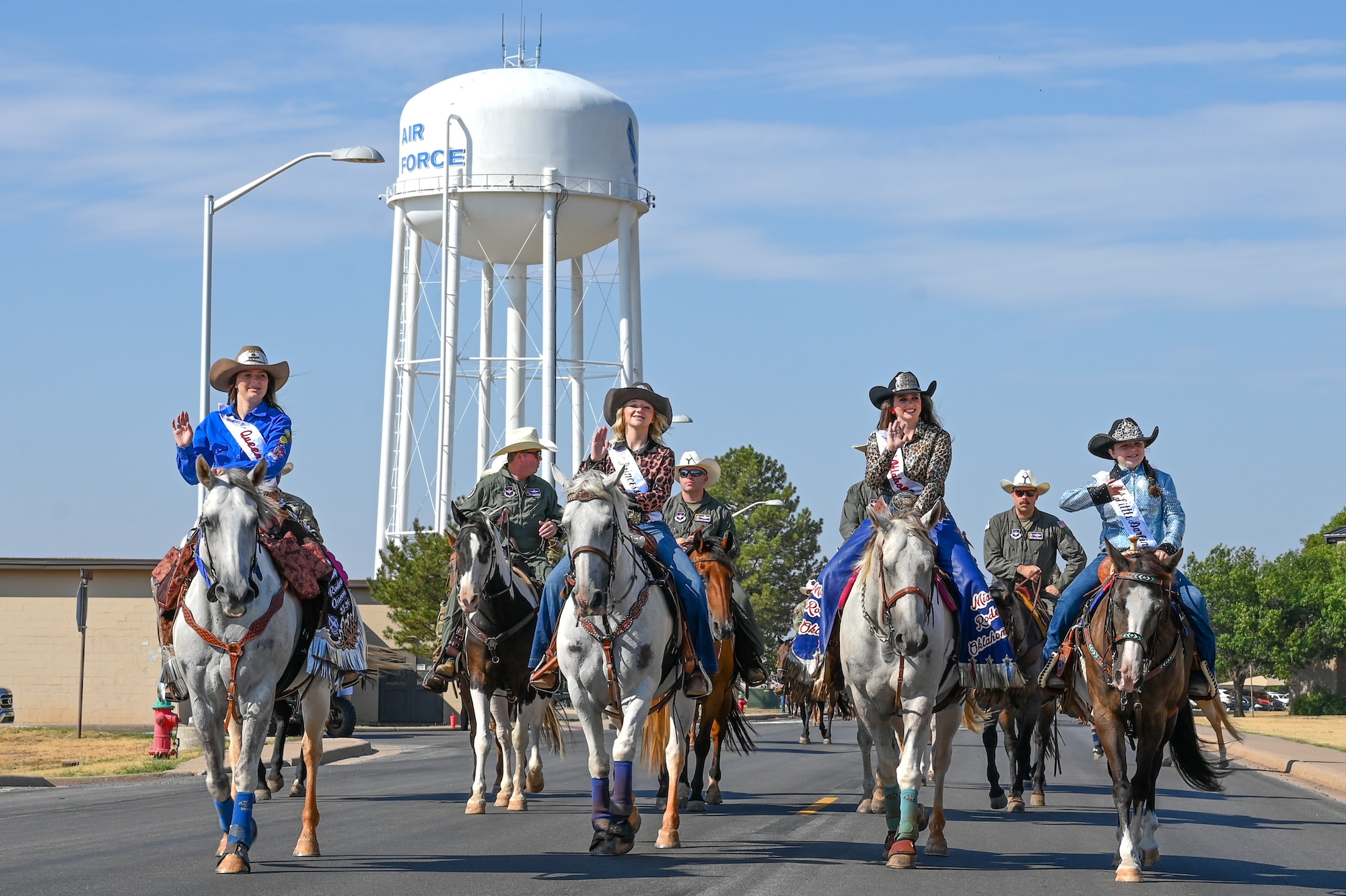 Rodeo queens from throughout Oklahoma lead the 26th Annual Cattle Drive at Altus Air Force
Base, Oklahoma, Aug. 22, 2024. The cattle drive is unique to Altus AFB, as it is the only military installation in the world to host this kind of event. (U.S. Air Force photo by Senior Airman Kari Degraffenreed)