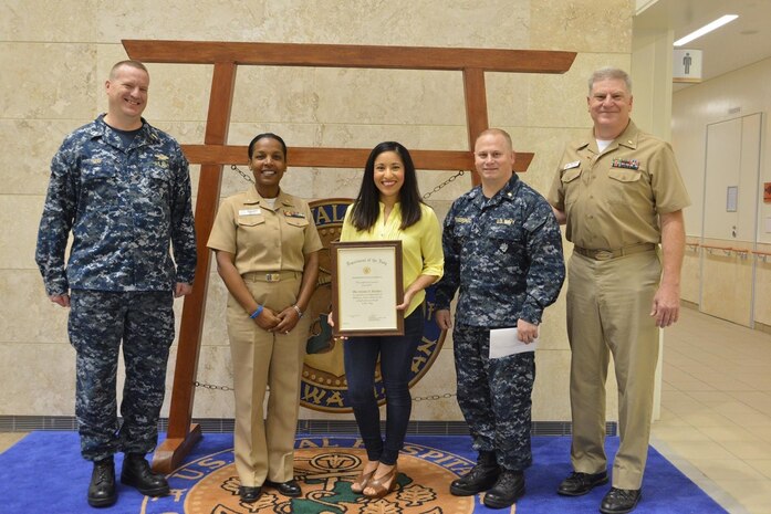 U.S. Air Force 1st Lt. Claudia Hinchey, 9th Medical Group resource management and commander’s support staff flight commander, poses for a picture with her leadership after winning the Civilian of the Year Award and Navy Meritorious Civilian Service Award when she used to work for the U.S. Naval Hospital at Camp Foster, Japan in 2016. (Courtesy Photo)