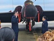 U.S. Air Force 1st Lt. Claudia Hinchey, 9th Medical Group resource management and commander’s support staff flight commander, is promoted by her husband, Lt. Col. William J. Hinchey, 9th Munitions Squadron commander, in front of a U-2 Dragon Lady at Beale Air Force Base, California, January 2024. (Courtesy Photo)