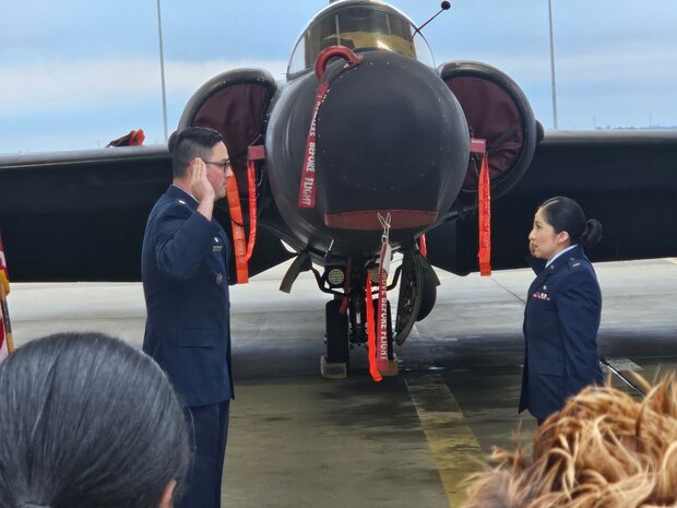 U.S. Air Force 1st Lt. Claudia Hinchey, 9th Medical Group resource management and commander’s support staff flight commander, is promoted by her husband, Lt. Col. William J. Hinchey, 9th Munitions Squadron commander, in front of a U-2 Dragon Lady at Beale Air Force Base, California, January 2024. (Courtesy Photo)