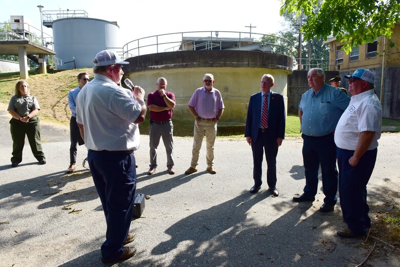 Steve Key (holding microphone), supervisor for the wastewater treatment plant in Carthage, Tennessee, briefs Congressman John Rose (wearing red and white striped tie), Tennessee 6th District; U.S. Army Corps of Engineers officials and guests about the Carthage Wastewater Treatment Plant Streambank Stabilization Project following an official signing of the Project Partnership Agreement Aug. 23, 2024. (USACE Photo by Lee Roberts)