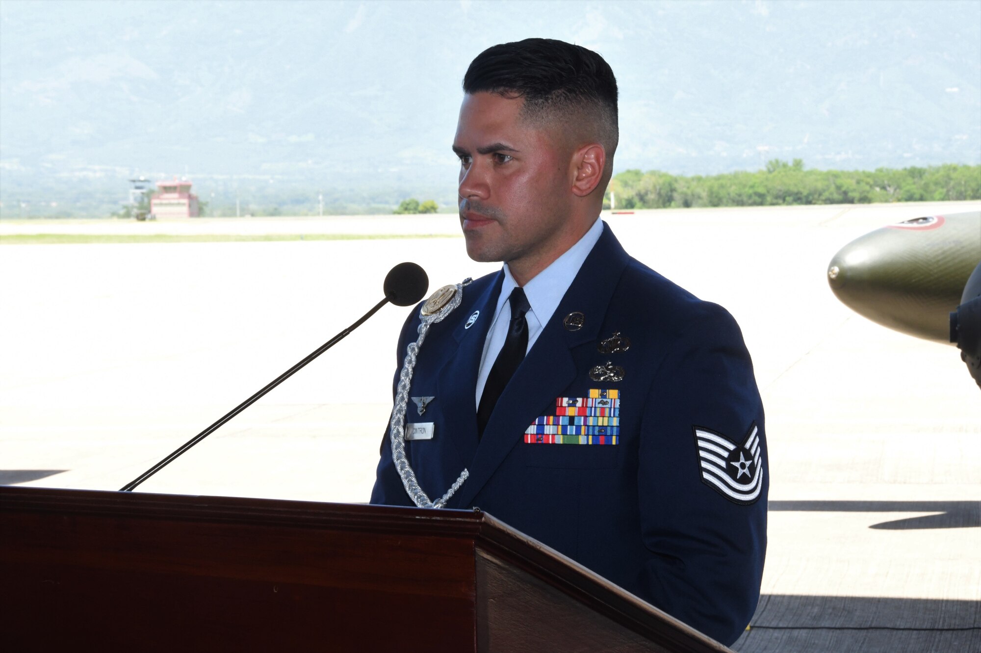 A photo of an Airmen talking to a crowd.
