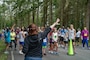 Robyn Gross, a Morale, Welfare and Recreation volunteer, directs race participants to their starting lines during the Deer Run at Naval Magazine Indian Island in Port Hadlock, Washington, Aug. 10, 2024. Approximately 100 runners and walkers participated in this year’s 5k and 1-mile Deer Run, which NMII hosts annually.