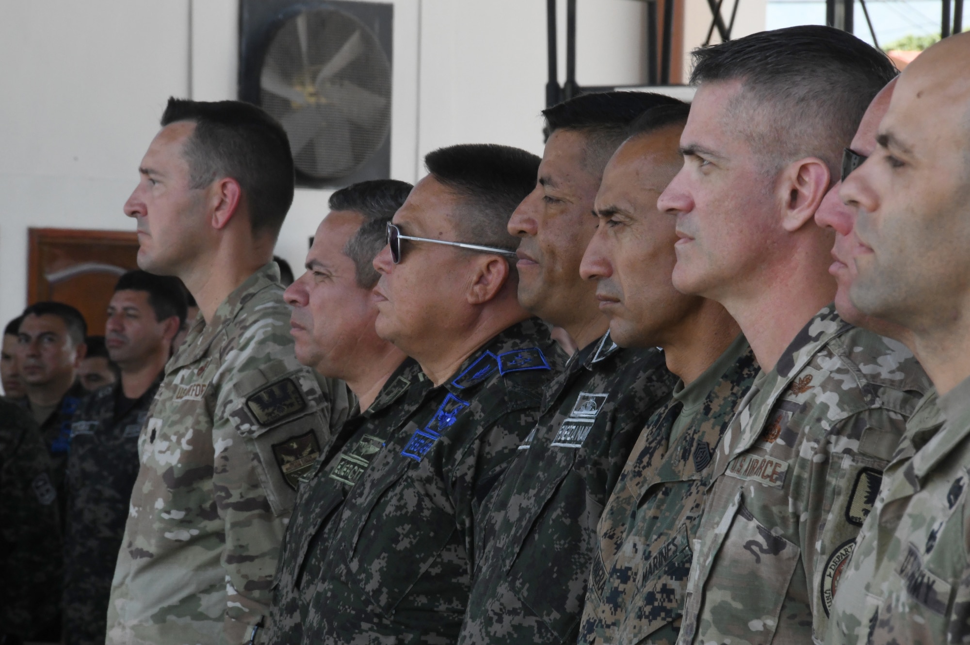 A photo of service members standing.