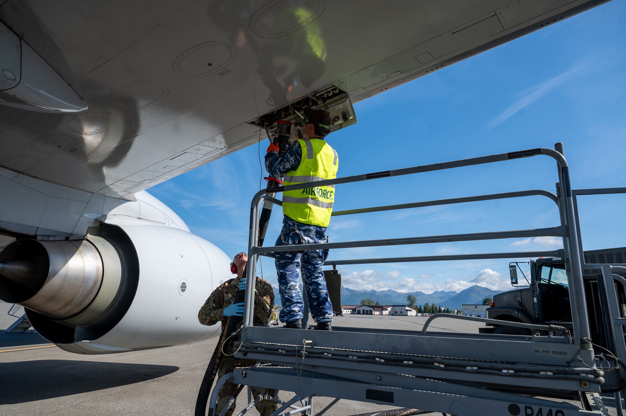 Royal Australian Air Force Cpl. Andrew Wong, an aircraft technician assigned to 2 Squadron, and U.S. Air Force Airman 1st Class Cody Britton, a fuels distribution operator assigned to the 673d Logistics Readiness Squadron, refuels a Royal Australian Air Force E-7A Wedgetail during Red Flag-Alaska 24-3 at Joint Base Elmendorf-Richardson, Alaska, Aug. 22, 2024.