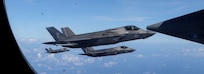 U.S. Marine Corps F-35B Lightning II strike fighter aircraft assigned to Marine Fighter Attack Squadron (VMFA) 121, 31st Marine Expeditionary Unit, fly alongside a KC-130J Super Hercules tanker aircraft assigned to Marine Aerial Refueler Transport Squadron (VMGR) 152, during an aerial refueling exercise in the vicinity of the Miyako Strait, Aug. 21, 2024.