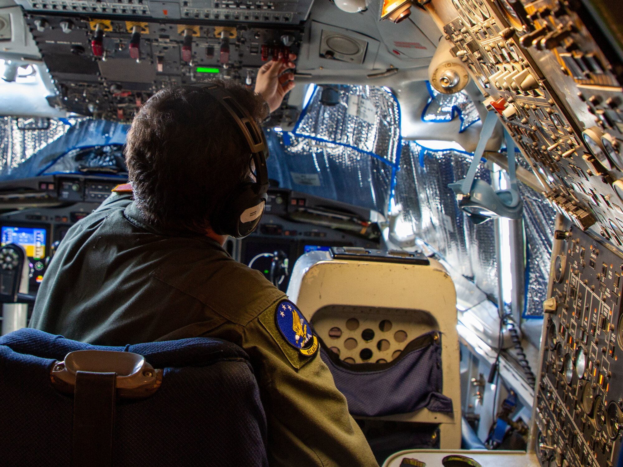 Senior Airman Owen Grissom, a flight engineer from the 552nd Airborne Air Control Squadron, conducts preflight checks onboard an E-3 Sentry during Bamboo Eagle 24-3 at Nellis Air Force Base, Nev., Aug. 8, 2024. The 552nd ACS plays a critical role in ensuring the E-3 is mission-ready for this large-scale exercise, which tests the integration of multiple air and ground assets. (U.S. Air Force photo by Garrett N. Cole)