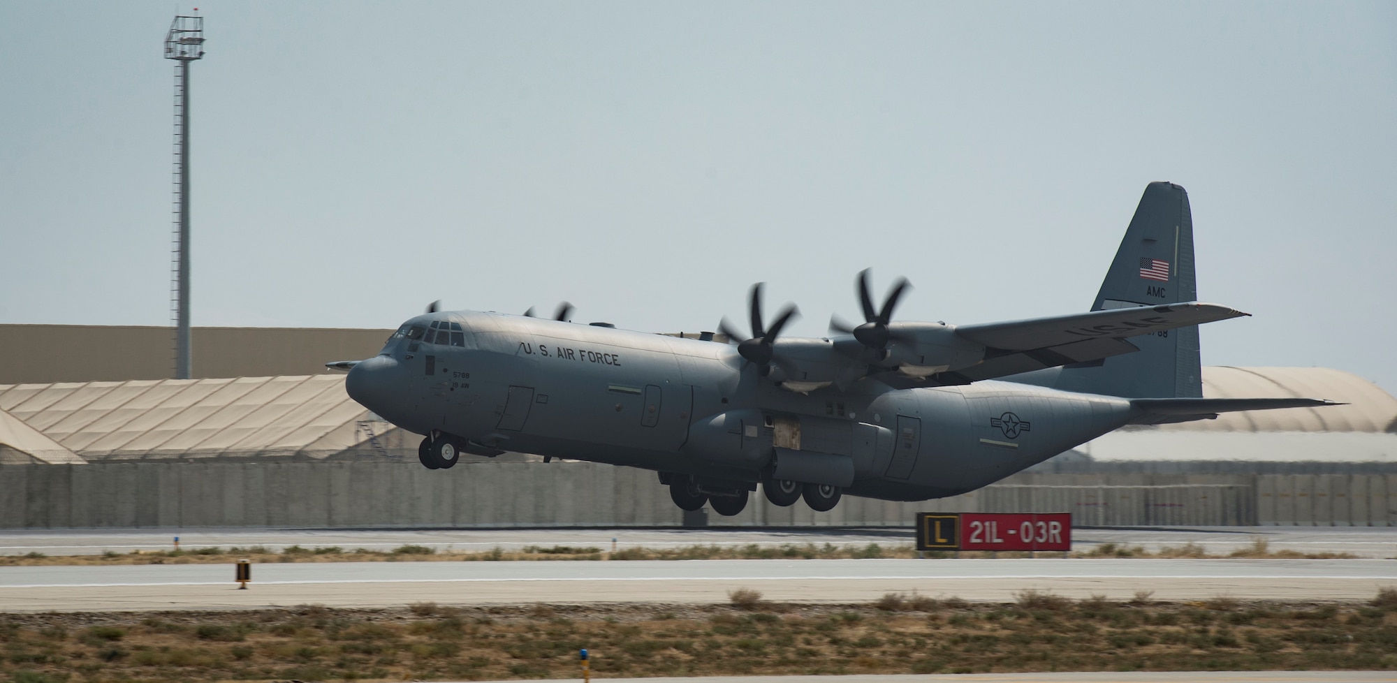 A C-130 takes off from the flight line.