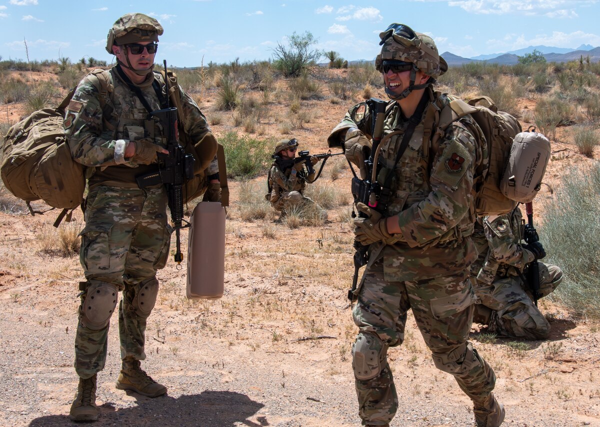 Two Air Force Airmen standing in the desert during a training exercise
