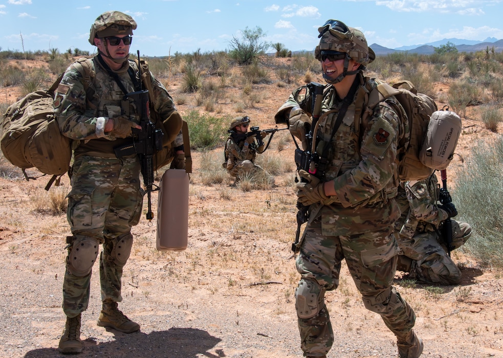 Two Air Force Airmen standing in the desert during a training exercise