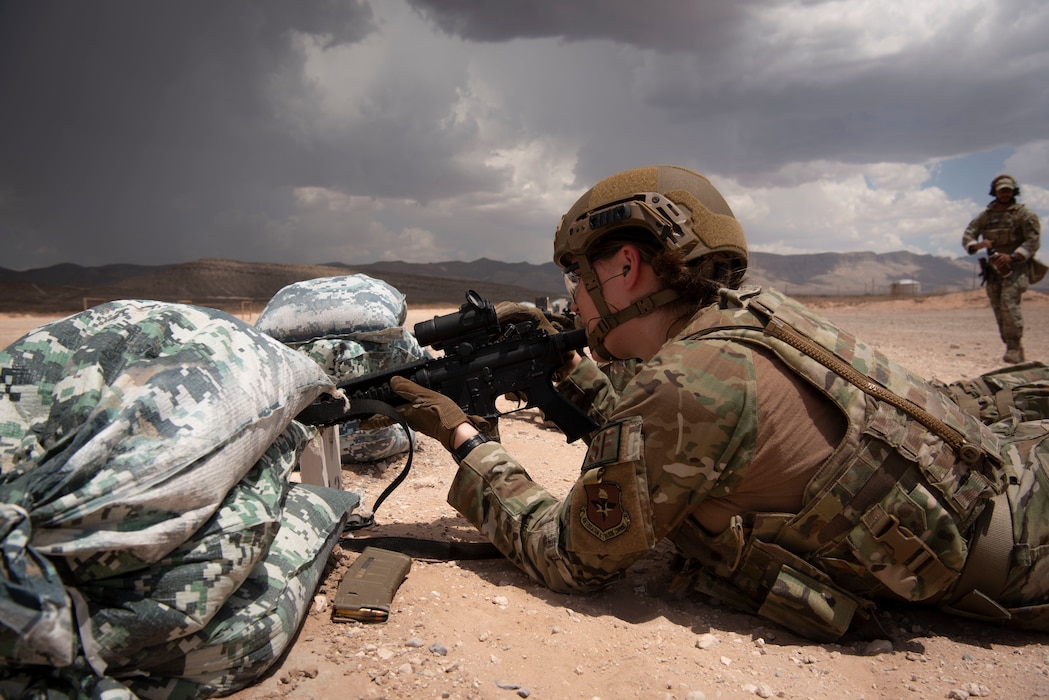 Airman is in prone position as they fire weapon at rifle range during training