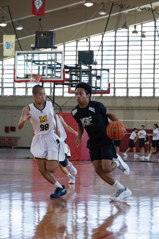 Players from the Minatogawa Junior High and the Camp Humphrey Hoops Club, play basketball during the End of Summer Friendship Tournament on Camp Foster, Okinawa, Japan, Aug. 10, 2024. The Okinawa 1215 Boys and Girls Basketball Club brought together eight teams from Japan and Korea to play in the End of Summer Friendship Tournament. (U.S. Marine Corps photo by Lance Cpl. Brody Robertson)