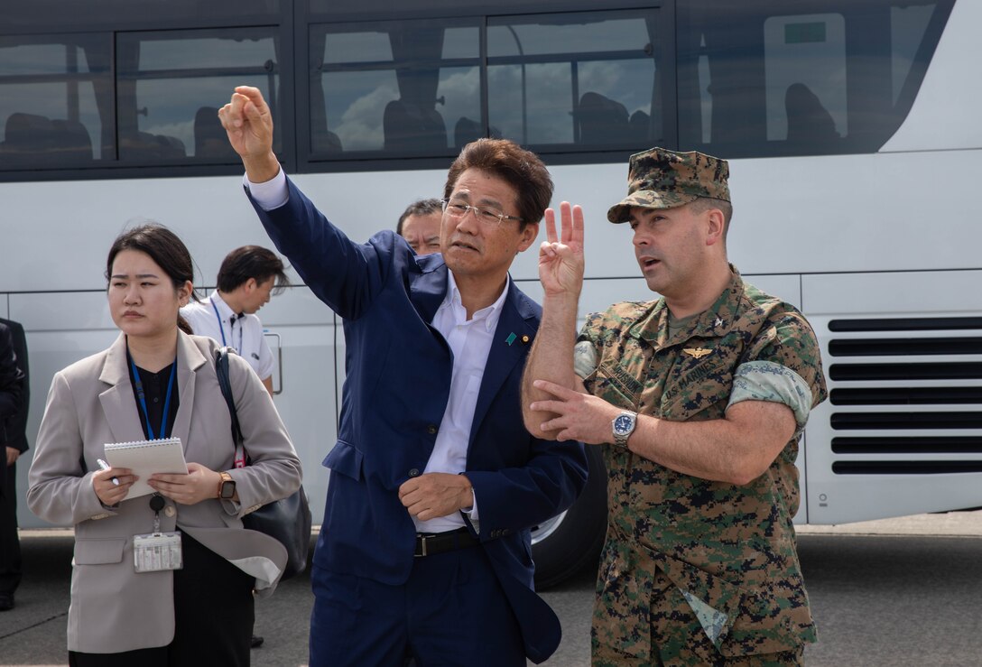 U.S. Marine Corps Col. Richard Rusnok, the commanding officer of Marine Corps Air Station Iwakuni and a Pennsylvania native, speaks with Shingo Miyake, the Parliamentary Vice-Minister of Defense, about the capabilities of the installations harbor during a tour of the air station at MCAS Iwakuni, Japan, July 25, 2024. Miyake visited MCAS Iwakuni to speak with leadership from the air station and better understand the installation's operational capabilities and the role of JSDF personnel stationed there. (U.S. Marine Corps photo by Lance Cpl. Micah Taylor)