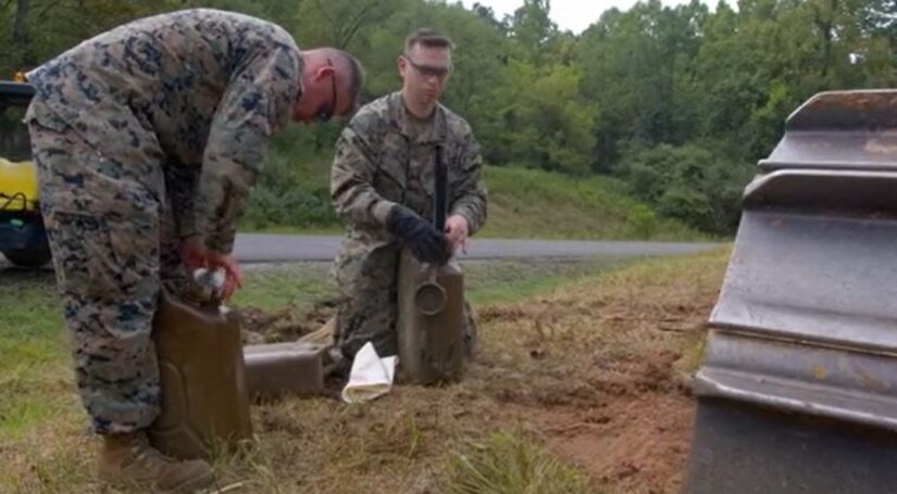 Marines work in a field.