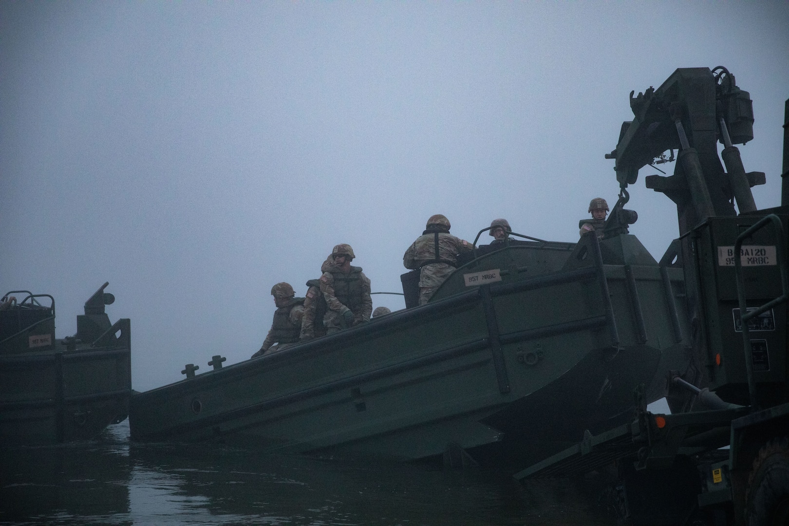 Soldiers with the 957th Multi-role Bridge Company, North Dakota Army National Guard, launch an M30 Bridge Erection Boat into the Missouri River during a wet gap crossing training exercise near Kimball Bottoms, North Dakota, Aug. 17, 2024. The boats are crucial for maneuvering bridge bays into position and holding the bridge steady during operations.