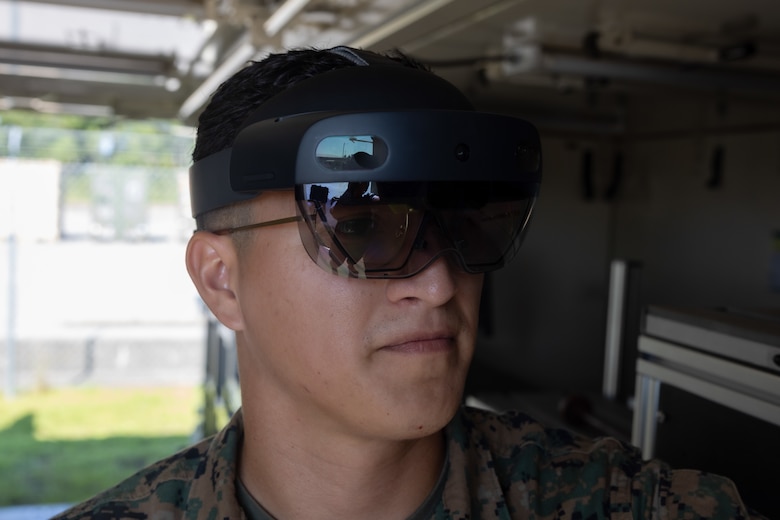 U.S. Marine Corps Cpl. Vradley Cerna, from Texas and a digital wideband systems maintainer with Marine Wing Communications Squadron (MWCS) 28, tests tele-maintenance capabilities at Marine Corps Air Station Cherry Point, North Carolina, Aug. 21, 2024. Marine Depot Maintenance Command is experimenting with augmented reality technology as part of its effort to modernize its maintenance capabilities from industrial-era practices to technologies suitable and capable of meeting the demands of the Information Age. (U.S. Marine Corps photo by Lance Cpl. Orlanys Diaz Figueroa)