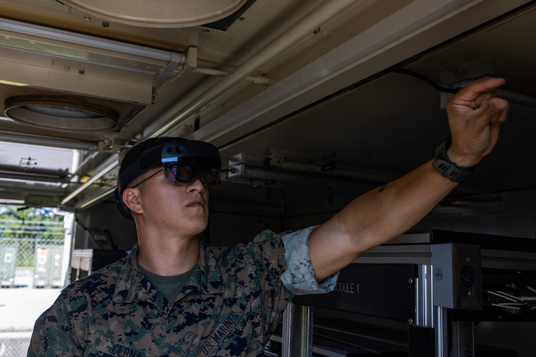 U.S. Marine Corps Cpl. Vradley Cerna, from Texas, a digital wideband systems maintainer with Marine Wing Communications Squadron (MWCS) 28, tests tele-maintenance capabilities at Marine Corps Air Station Cherry Point, North Carolina, Aug. 21, 2024. Marine Depot Maintenance Command is experimenting with augmented reality technology as part of its effort to modernize its maintenance capabilities from industrial-era practices to technologies suitable and capable of meeting the demands of the Information Age. (U.S. Marine Corps photo by Lance Cpl. Orlanys Diaz Figueroa)