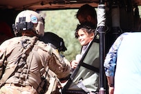 An Arizona Army National Guard Soldier helps a child into a UH-60 Black Hawk helicopter Aug. 24, 2024, at the Havasupai Indian Reservation. More than 100 people were evacuated out of the canyon after flood waters impacted the Havasupai community and tourists visiting Havasupai Falls.