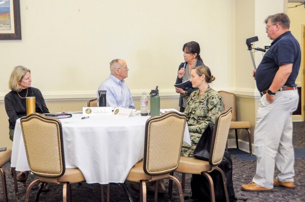 Sandy Martinez, a contractor with the environmental health directorate, at the Navy and Marine Corps Force Health Protection Command, speaks with Dr. Paul Rockswold, center, an epidemiologist with the Defense Centers for Public Health – Portsmouth (DCPH-P) during a roving interview at risk communication workshop Aug. 15, 2024, at the Rivers Edge Conference Center, on Naval Medical Center Portsmouth, Virginia. The risk communication workshop focused on how to plan and execute communications to internal and external stakeholders on any public health issue that impacts their mission. Stationary and roving interviews were conducted to allow the students to apply some of the speaking techniques they have learned from the workshop. (Navy photo by Desmond Martin)