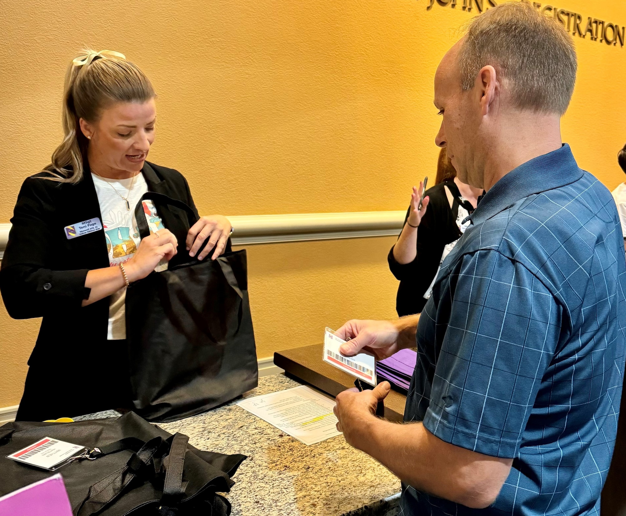 a person checks another into a conference
