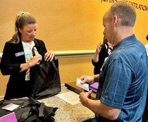 a person checks another into a conference
