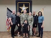 Capt. Mckenzie N. Elliott, commander, Headquarters and Headquarters Company, Special Troops Battalion, 1st Theater Sustainment Command; her husband, Capt. Andy Elliott and family members stand together at her Assumption of Command, April 19, 2024, Fort Knox, Kentucky. Elliott is a member of the small, tight-knit Explosive Ordnance community.