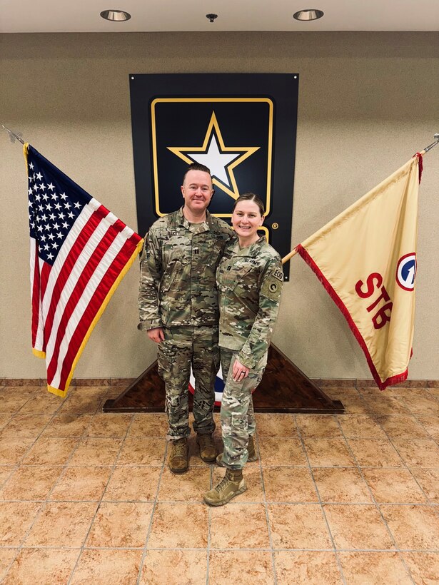 Capt. Mckenzie N. Elliott, commander, Headquarters and Headquarters Company, Special Troops Battalion, 1st Theater Sustainment Command, stands with her husband, Capt. Andy Elliott at her April 19, 2024, Assumption of Command at Fort Knox, Kentucky. Elliott is an Explosive Ordnance Officer.