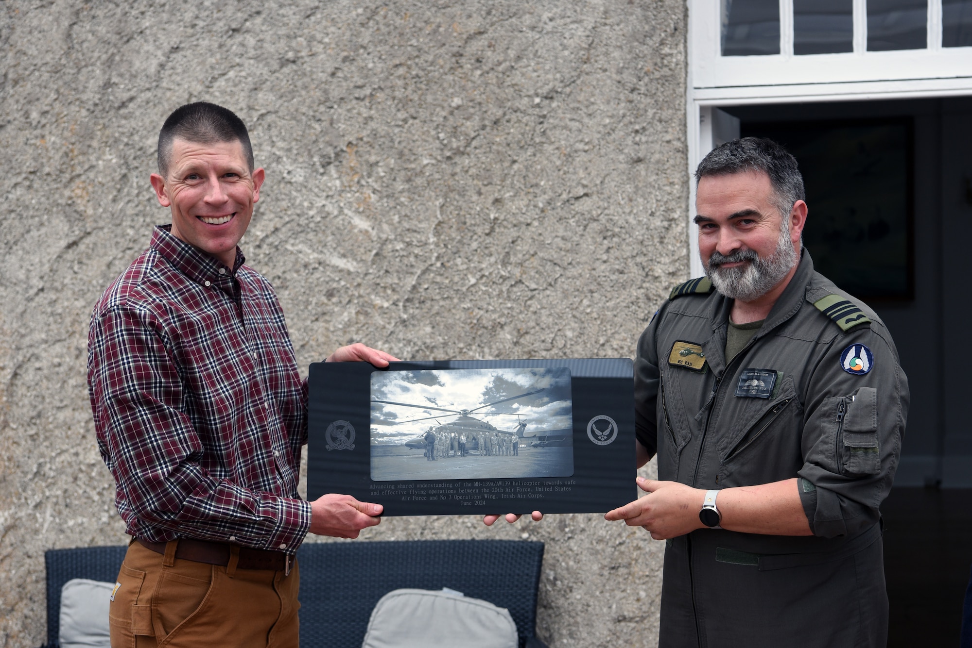 U.S. Air Force Col. Philip Bryant, 582nd Helicopter Group commander, receives a gift from the Irish Air Corps following a tour of Casement Aerodrome in Baldonnel, Ireland, June 26, 2024. Airmen from Twentieth Air Force and Air Force Global Strike Command visited with the IAC June 22-29, 2024 to discuss a mutually beneficial partnership with exchanges of personnel to provide U.S. pilots with training in the AW-139 by experienced instructors at Casement Aerodrome in Baldonnel and provide Irish pilots with an experience flying in mountainous terrain through the High Alpine Advanced Flying Technique course at Malmstrom Air Force Base, Montana.