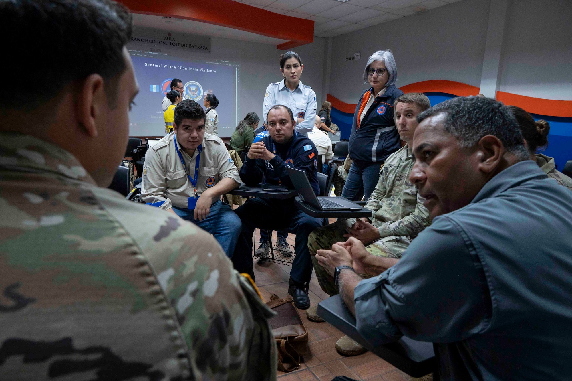 A photo of a group of people sitting and talking together.