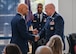 U.S. Air Force Lt. Gen. Brian S. Robinson, Air Education and Training Command commander, shakes hands with Maj. Ge. Thomas Harrell, Air Force Medical Command Medical Readiness-Alpha, at the 59th Medical Wing change of command ceremony Aug. 23, 2024.