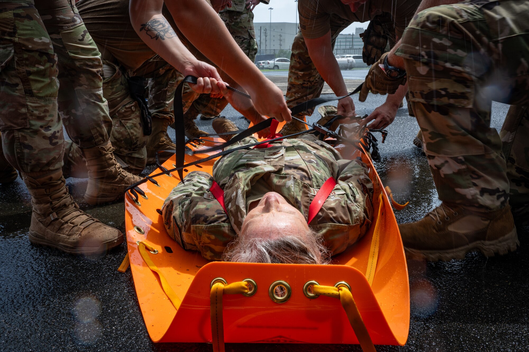U.S. Air Force Col. Brenda Brinkley, commander, 125th Medical Group, Florida Air National Guard volunteers to demonstrate how to put a person on an evacuation sled as part of Confined Space Rescue(CSR) training, during an exercise Aug. 13, 2024, at Fort Buchanan, Puerto Rico. The exercise is comprised of several training events that enhances air-load capabilities, refines pre- and post- deployment procedures, expands mission readiness in an unfamiliar environment, and fulfills Comprehensive Medical Readiness Plan requirements, including critical care, search and extraction, and Air Force Specialty Code proficiency training, while collaborating with the 156th Medical Group. The exercise also includes providing Individual Medical Readiness support for members of the 156th Wing population. (U.S. Air National Guard photo by Senior Airman Jesse Hanson)