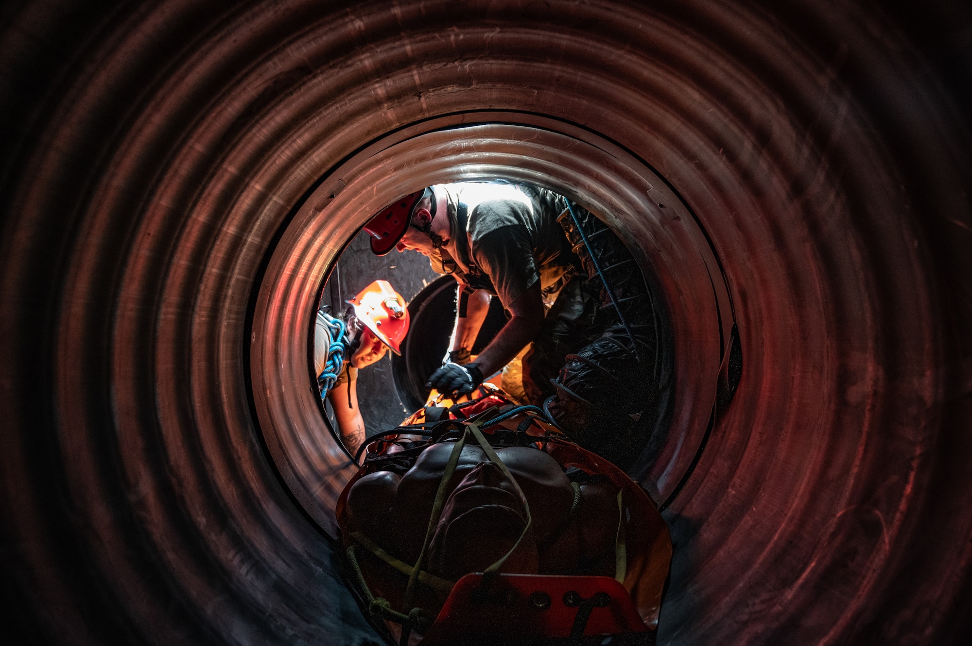 U.S. Air Force Senior Airman Anjelica March, search and rescue medic and unit deployment manager(LEFT) and Capt. Matthew Gullick, emergency nurse, both assigned to the 125th Medical Group, Detachment 1, Florida Air National Guard make their way through a Confined Space Rescue(CSR) course as part of CSR training, during an exercise Aug. 13, 2024, Fort Buchanan, Puerto Rico. The exercise is comprised of several training events that enhances air-load capabilities, refines pre- and post- deployment procedures, expands mission readiness in an unfamiliar environment, and fulfills Comprehensive Medical Readiness Plan requirements, including critical care, search and extraction, and Air Force Specialty Code proficiency training, while collaborating with the 156th Medical Group. The exercise also includes providing Individual Medical Readiness support for members of the 156th WG population. (U.S. Air National Guard photo by Senior Airman Jesse Hanson)