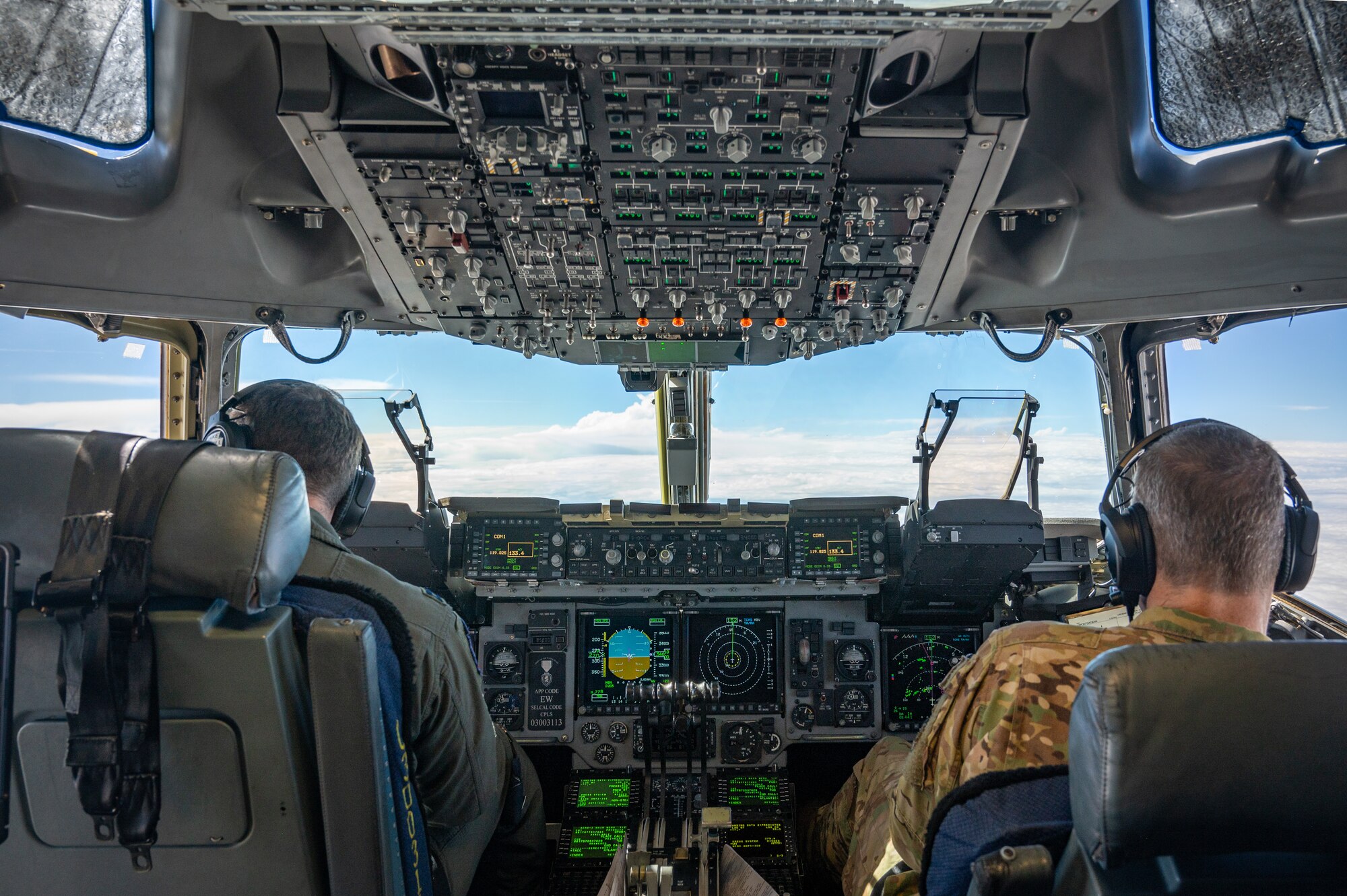 U.S. Airmen assigned to the Mississippi Air National Guard pilot a C-17 Globemaster Aug. 8, 2024, in route to Muñiz Air National Guard Base, Carolina, Puerto Rico. The aircraft is carrying Airmen assigned to the 125th Medical Group as they conduct a training exercise that enhances air-load capabilities, refines pre- and post- deployment procedures, expands mission readiness in an unfamiliar environment, and fulfills Comprehensive Medical Readiness Plan requirements, including critical care, search and extraction, and Air Force Specialty Code proficiency training, while collaborating with the 156th Medical Group. The exercise also includes providing Individual Medical Readiness support for members of the 156th Wing population. (U.S. Air National Guard photo by Senior Airman Jesse Hanson)