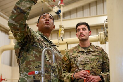 New York Air National Guard Master Sgt. Anderson Brooks, with the 105th Airlift Wing's Civil Engineer Squadron, and U.S. Air Force Tech Sgt. David Proebstel, with the 765th Air Base Squadron, review fuels systems at Lajes Field, Terceira Island, Azores, Portugal, Aug. 7, 2024. Airmen from the 105th CES deployed to the Azores for training.