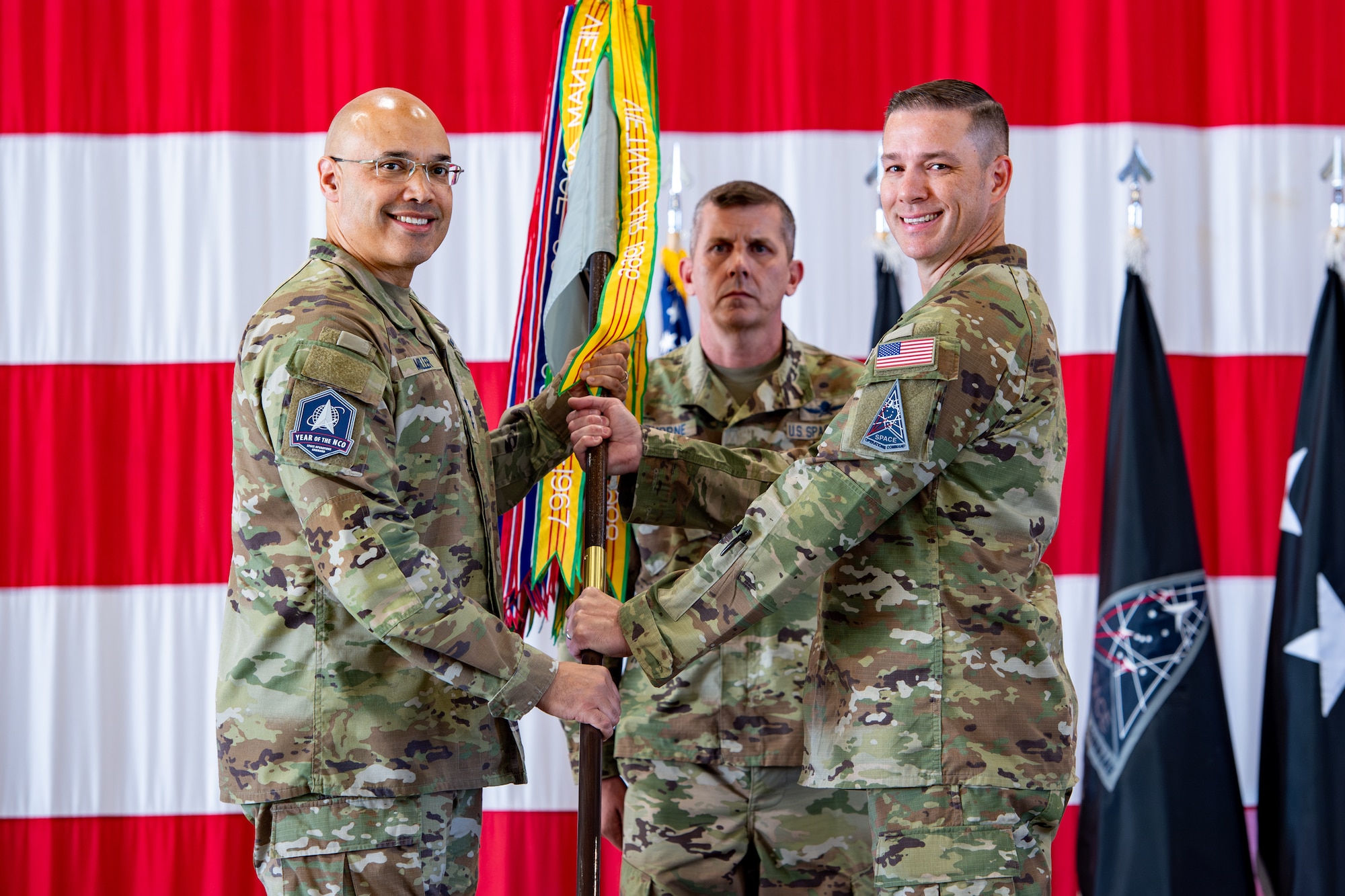 Col. Travis Prater, right, takes command of Space Delta 6 - Space Access and Cyberspace Operations, from Lt. Gen. David N. Miller, Jr, Space Operations Command commander, left, during a change of command ceremony.