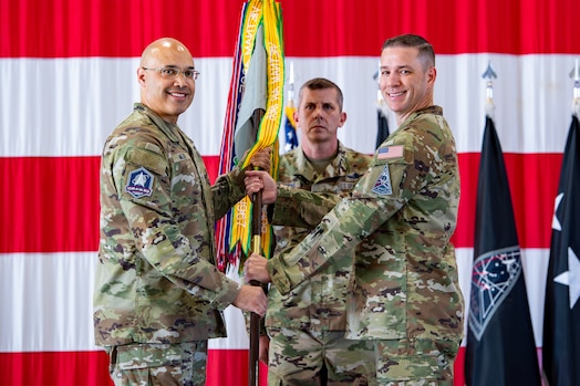  Col. Travis Prater, right, takes command of Space Delta 6 - Space Access and Cyberspace Operations, from Lt. Gen. David N. Miller, Jr, Space Operations Command commander, left, during a change of command ceremony.