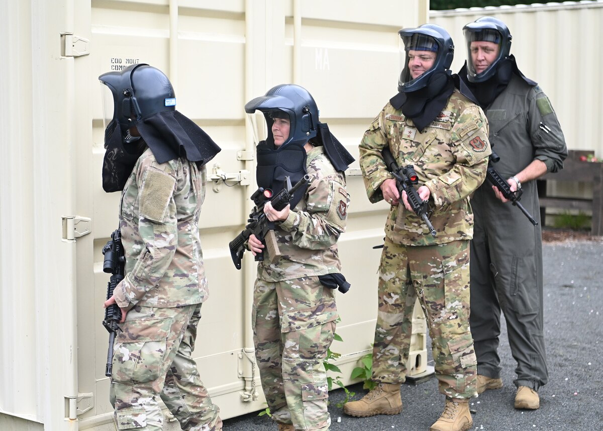 Four Air Force Reserve senior leaders participate in a building clearing exercise at Westover’s Dogpatch training area, Aug 7.  They are standing one behind each other, wearing protective helmets and face shields, and carrying training/non-firing rifles. 
The exercise allowed participants to experience first-hand the current training Airmen are required to undergo and accel at, to prepare for the battlefield.  A two-day warfighting conference was hosted by Westover Reserve Air Force Base with Lt. Gen. John. Healy, Chief of Air Force Reserve, in attendance to ensure Airman are “Ready Now” to fight tonight and have the tools and equipment to transform for future threats as assets in the nation’s defense.
