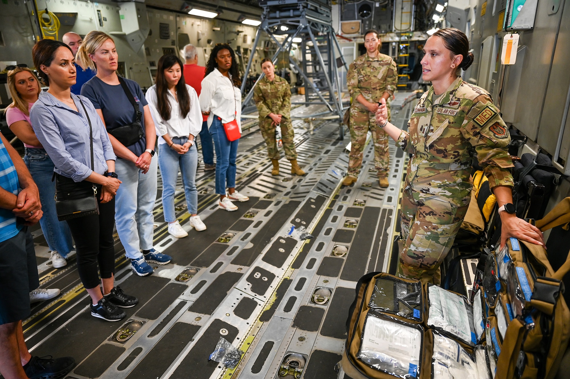 Capt. Alexandra Cunningham, 445th Aeromedical Evacuation Squadron flight nurse, briefs potential recruits on the AES mission and career fields during a C-17 Globemaster III tour at Wright-Patterson Air Force Base, Ohio. The potential flight doctors and flight nurses also received information on the benefits of being a Reservist as part of the 445th Airlift Wing’s Health Professions Recruiting event, Aug. 4, 2024.