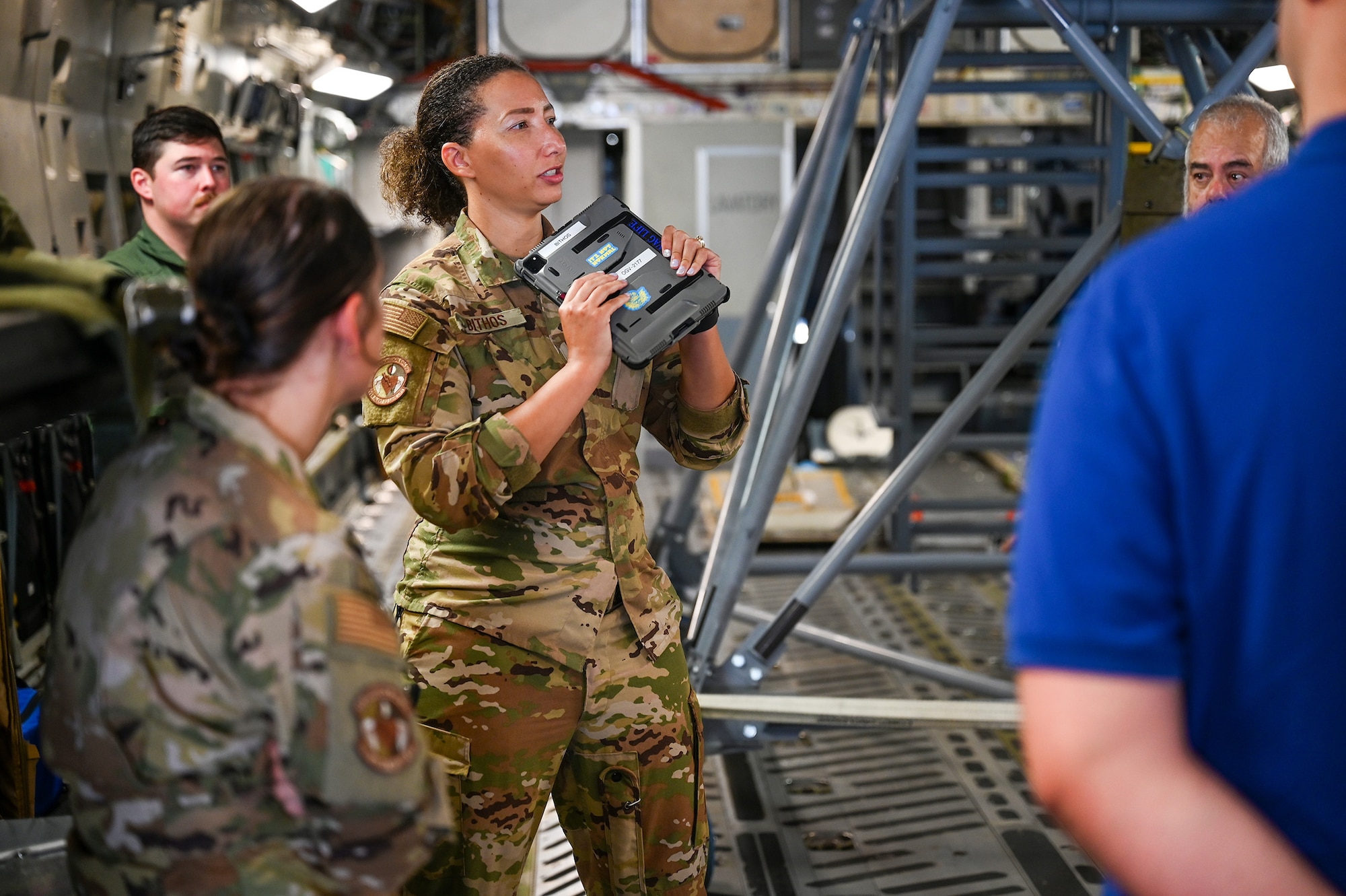 Capt. Devona Bithos, 445th Aeromedical Evacuation Squadron flight nurse, talks to potential recruits onboard a C-17 Globemaster III conjured as a flying hospital about her role as a flight nurse and being an Air Force reservist during the 445th Airlift Wing health professions recruiting event Aug. 3, 2024. The event was tailored for those interested in becoming a flight nurse, flight doctor or flying medical technician.