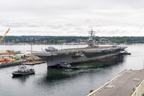 Sailors line the flight deck as USS Ronald Reagan (CVN 76) arrives at its new homeport on Naval Base Kitsap-Bremerton, Aug. 13, 2024. The Nimitz-class carrier will soon begin a scheduled Docking Planned Incremental Availability at Puget Sound Naval Shipyard & Intermediate Maintenance Facility in Bremerton, Washington. (U.S. Navy photo by Wendy Hallmark)