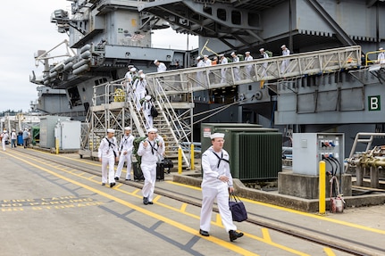 Sailors depart USS Ronald Regan (CVN 76), Aug. 13, 2024, after arriving at their new homeport on Naval Base Kitsap-Bremerton-Washington. (U.S. Navy photo by Jeb Fach)