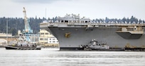 Sailors line the flight deck as USS Ronald Reagan (CVN 76) makes its way through Rich Passage, Aug. 13, 2024, en route to its new homeport on Naval Base Kitsap-Bremerton, Washington. (U.S. Navy photo by Scott Hansen)