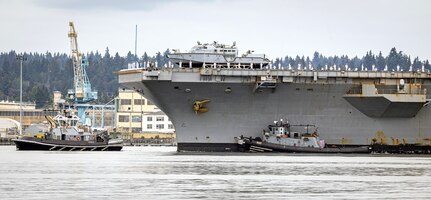 Sailors line the flight deck as USS Ronald Reagan (CVN 76) makes its way through Rich Passage, Aug. 13, 2024, en route to its new homeport on Naval Base Kitsap-Bremerton, Washington. (U.S. Navy photo by Scott Hansen)