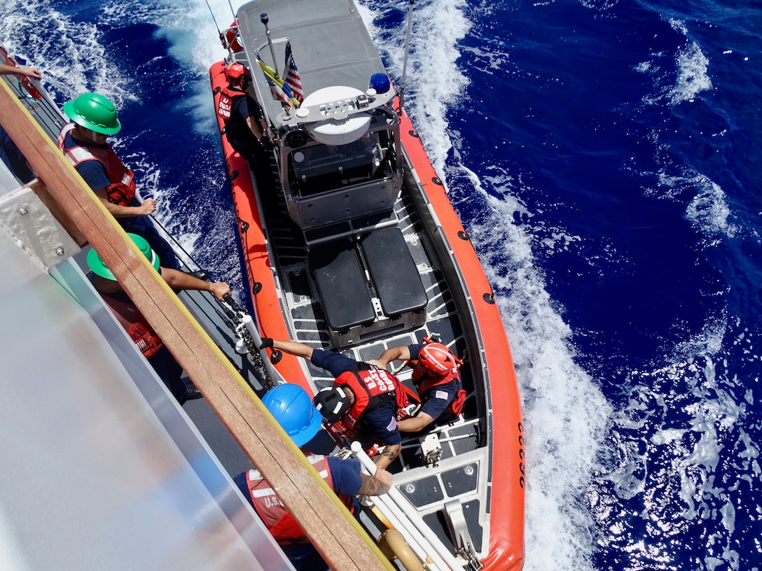 The crew of the USCGC Frederick Hatch (WPC 1143) return from a boarding on July 31, 2024, on the high seas of the Pacific Ocean. During this patrol, the Frederick Hatch team boarded two foreign-flagged fishing vessels in the Western and Central Pacific Fisheries Commission (WCPFC) operational area on the high seas, with no violations reported, ensuring the safety and security of the region's maritime activities. (U.S. Coast Guard photo)