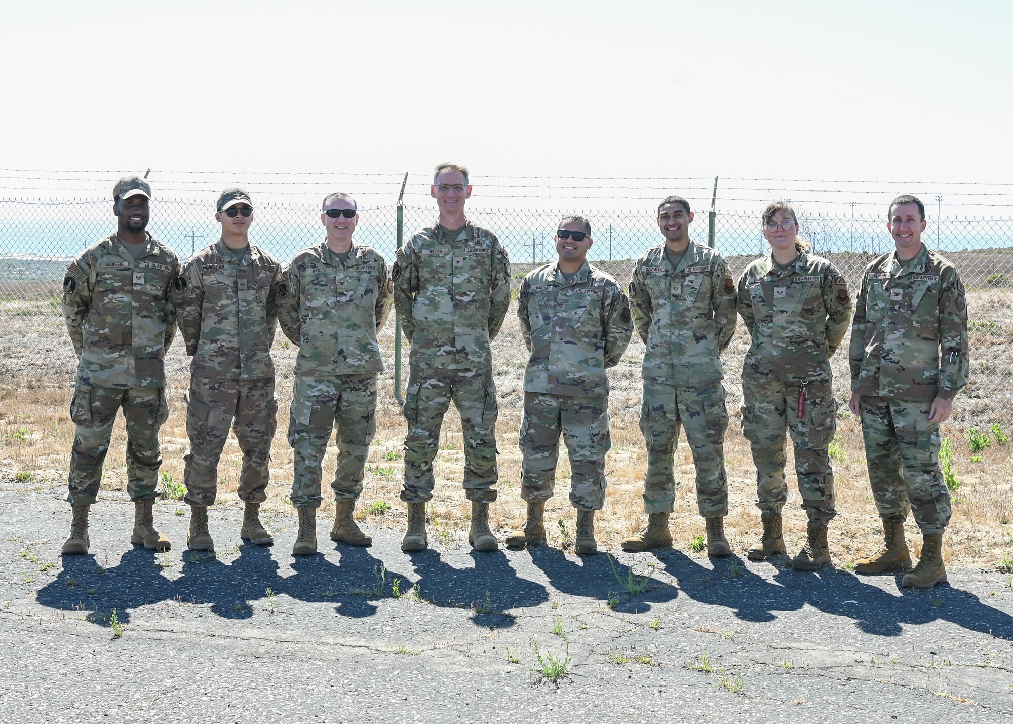 An Air Force Global Strike Command logistics and engineering director (middle left) poses for a group photo with members of the 377th Test and Evaluation Group during a tour of Launch Facility 10 at Vandenberg Space Force Base.