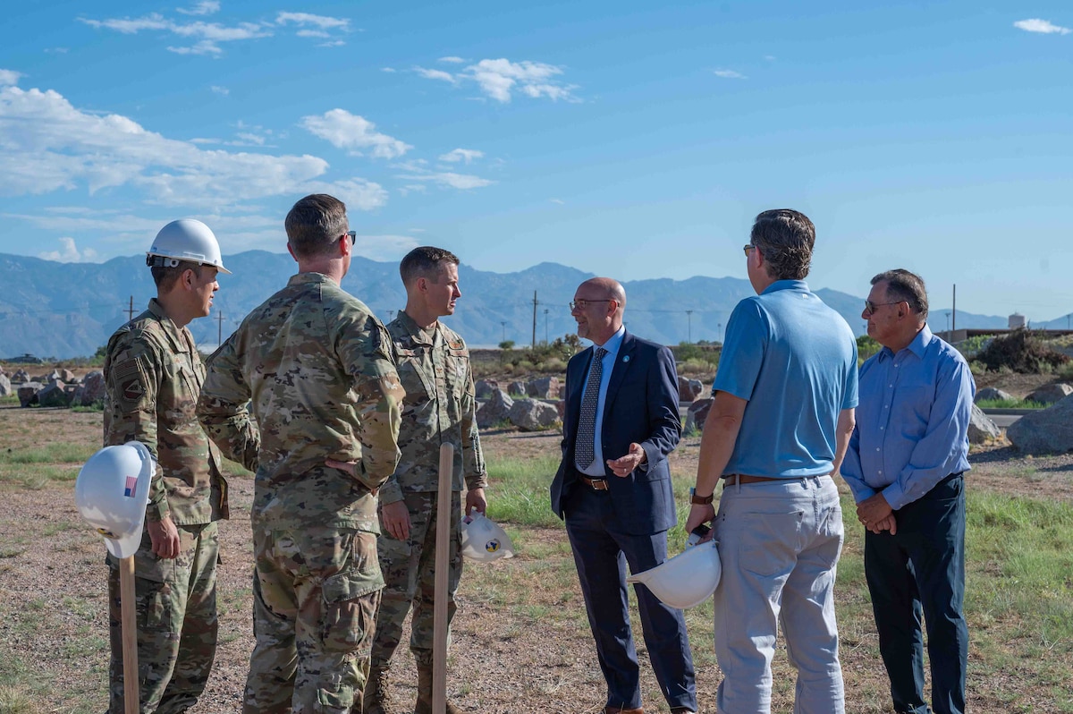 A group of men talk.