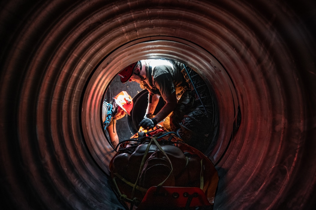 U.S. Air Force Senior Airman Anjelica March, search and rescue medic and unit deployment manager, left, and Capt. Matthew Gullick, emergency nurse, both assigned to the 125th Medical Group, Detachment 1, Florida Air National Guard make their way through a Confined Space Rescue course as part of CSR training, during an exercise Aug. 13, 2024, Fort Buchanan, Puerto Rico. The exercise is comprised of several training events that enhances air-load capabilities, refines pre- and post- deployment procedures, expands mission readiness in an unfamiliar environment, and fulfills Comprehensive Medical Readiness Plan requirements, including critical care, search and extraction, and Air Force Specialty Code proficiency training, while collaborating with the 156th Medical Group. The exercise also includes providing Individual Medical Readiness support for members of the 156th WG population. (U.S. Air National Guard photo by Senior Airman Jesse Hanson)