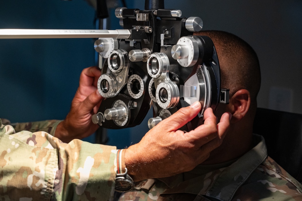 U.S. Air Force Lt. Col William Raimundi, 156th Medical Group optometrist, performs a vision exam during an exercise Aug. 9, 2024, at Muñiz Air National Guard Base, Carolina, Puerto Rico. The exercise is part of the 125th Medical Group, Detachment 1’s training that enhances air-load capabilities, refines pre- and post- deployment procedures, expands mission readiness in an unfamiliar environment, and fulfills Comprehensive Medical Readiness Plan requirements, including critical care, search and extraction, and Air Force Specialty Code proficiency training, while collaborating with the 156th Medical Group. The exercise also includes providing Individual Medical Readiness support for members of the 156th WG population. (U.S. Air National Guard photo by Senior Airman Jesse Hanson)