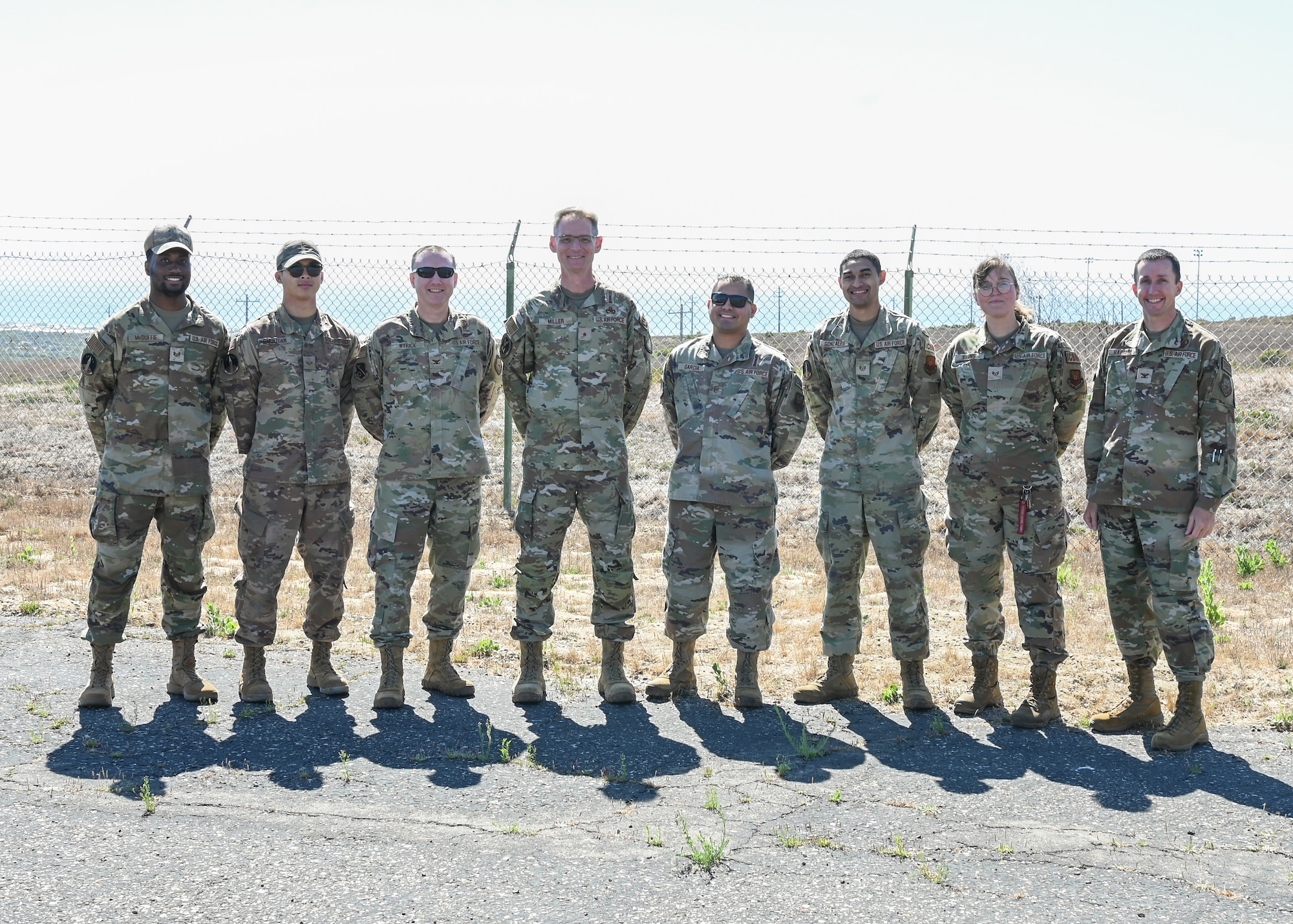 An Air Force Global Strike Command logistics and engineering director (middle left) poses for a group photo with members of the 377th Test and Evaluation Group during a tour of Launch Facility 10 at Vandenberg Space Force Base.