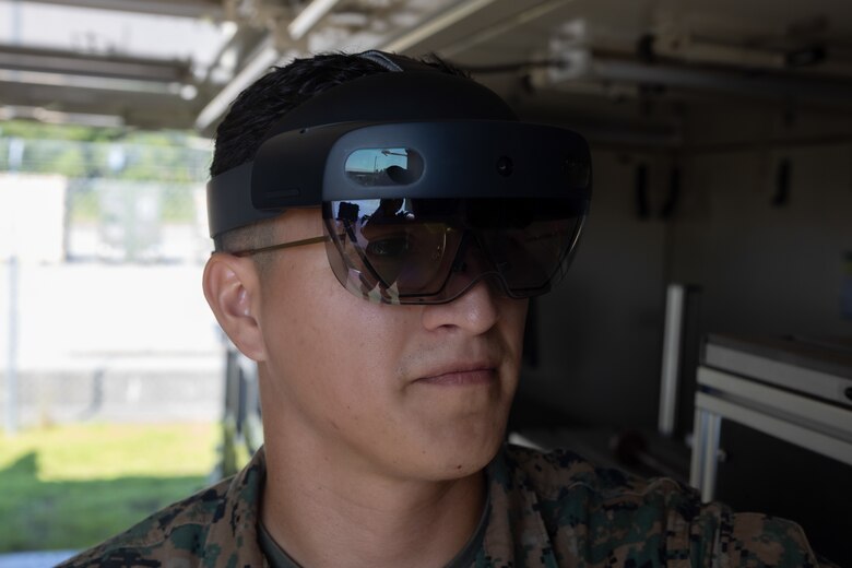 U.S. Marine Corps Cpl. Vradley Cerna, from Texas and a digital wideband systems maintainer with Marine Wing Communications Squadron (MWCS) 28, tests tele-maintenance capabilities at Marine Corps Air Station Cherry Point, North Carolina, Aug. 21, 2024. Marine Depot Maintenance Command is experimenting with augmented reality technology as part of its effort to modernize its maintenance capabilities from industrial-era practices to technologies suitable and capable of meeting the demands of the Information Age. (U.S. Marine Corps photo by Lance Cpl. Orlanys Diaz Figueroa)